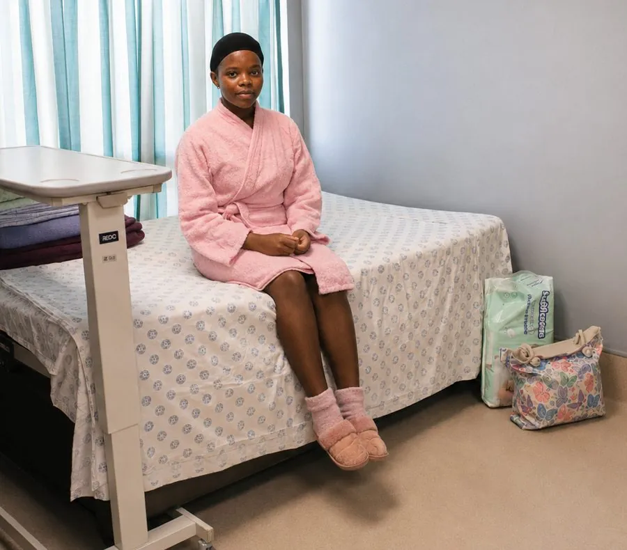 A new mother sitting in her hospital bed