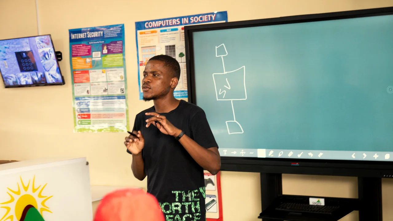 A facilitator presenting a lesson at the interactive screen