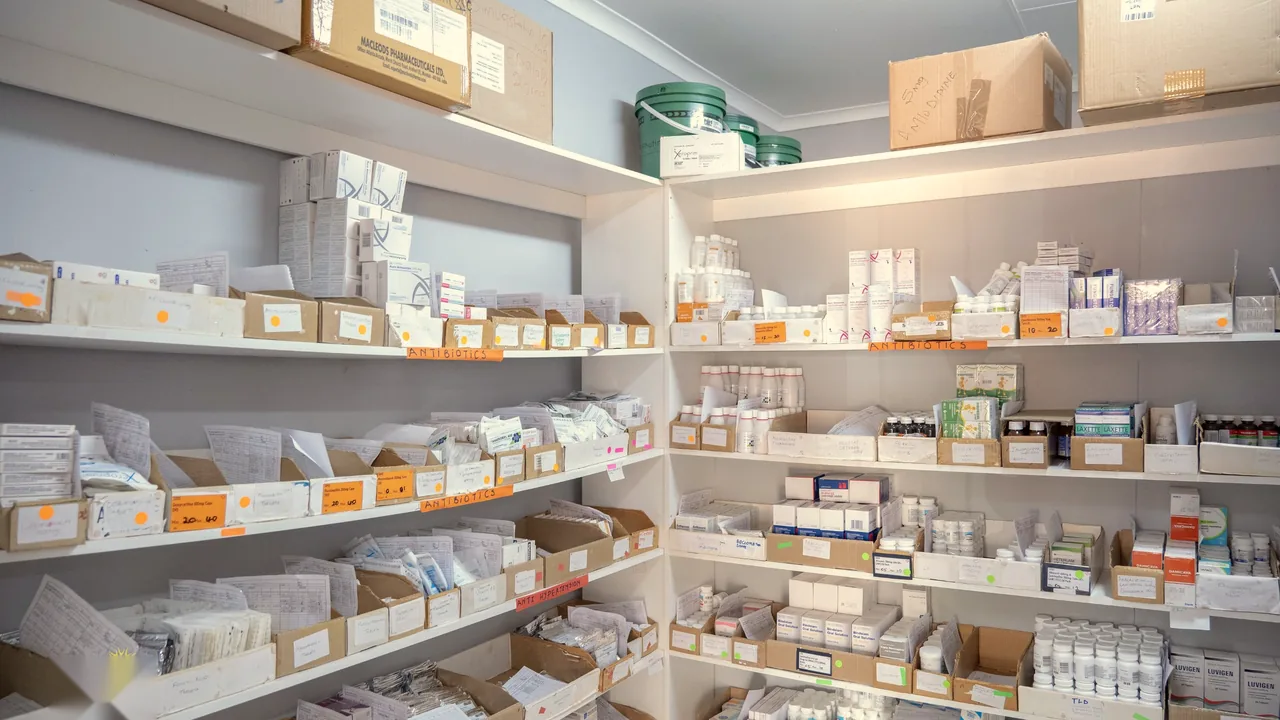 The clinic dispensary with shelves of stocked medicine