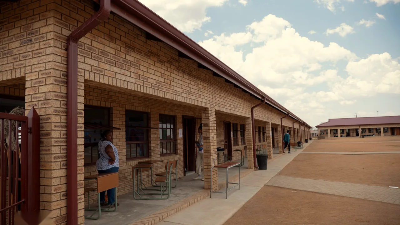 A covered walkway along the new brick classroom block