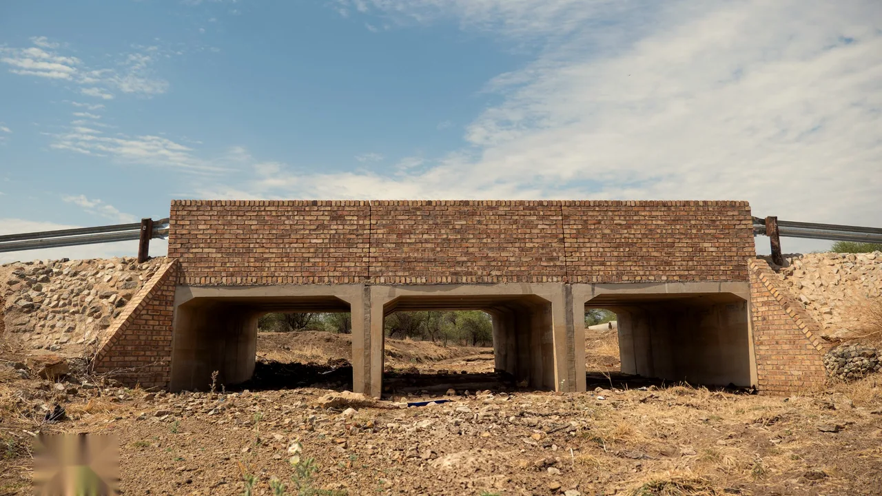 The three-cell concrete and brick bridge at Sefikile seen from the dry stream bed
