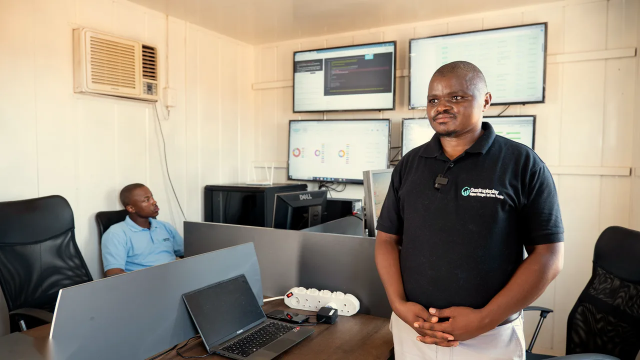 Technicians at work in the network operations room with monitoring screens