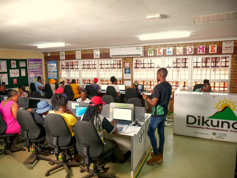 Community members learning computer skills in the ICT centre