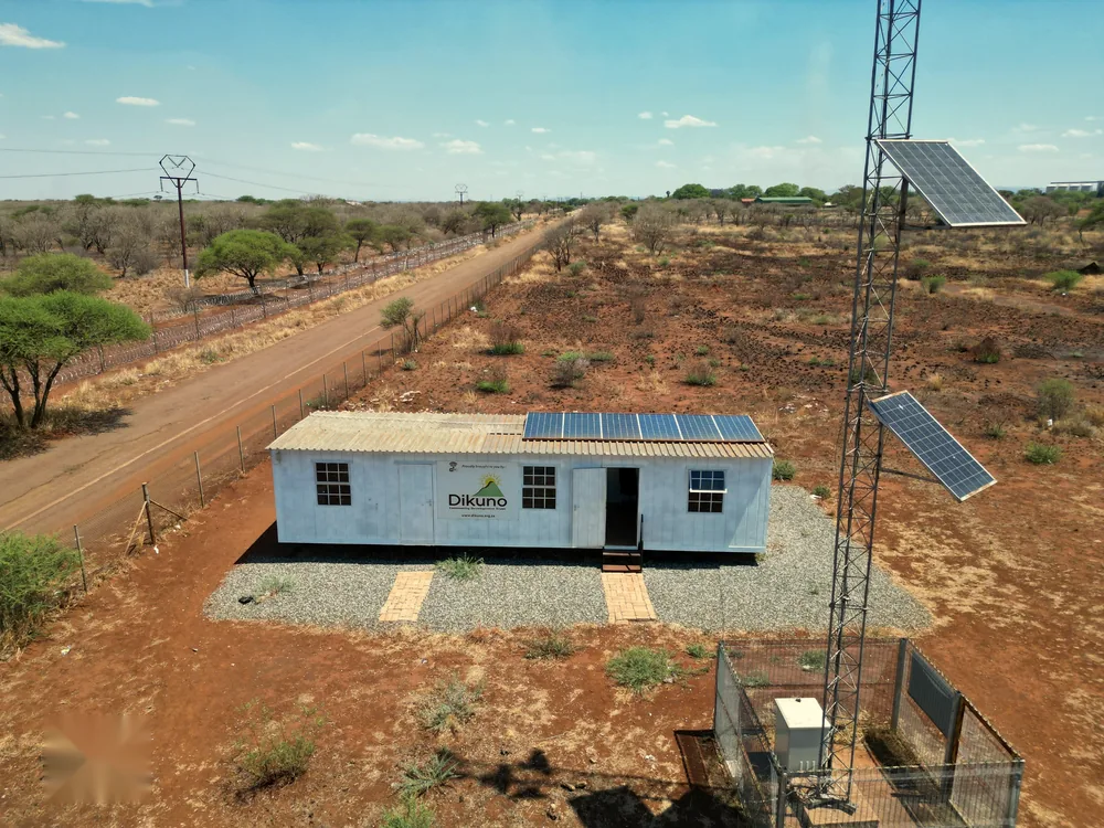 A solar-powered free Wi-Fi hub beside a communications tower